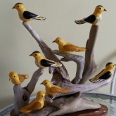 A cluster of yellow birds wood carving by Charlie Poirier, Cheticamp, Nova Scotia